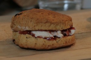 Homemade scone with strawberry jam and cream